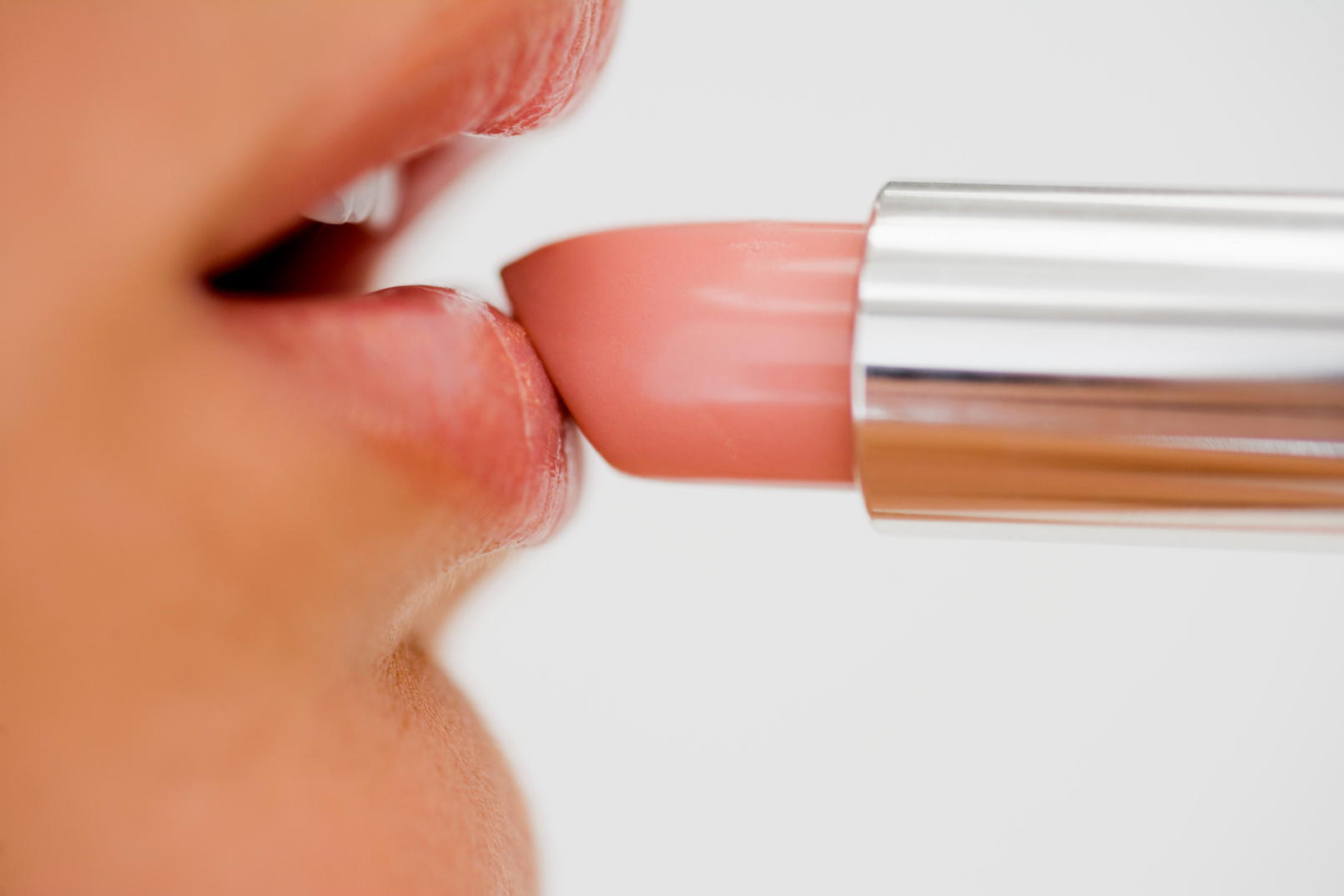 Woman applying lipstick