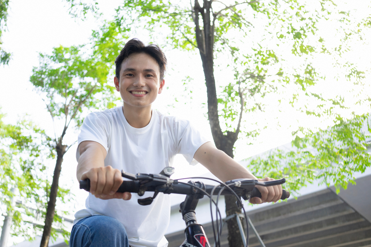Portrait of young Asian man outside